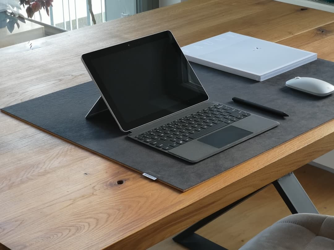 A diverse business team collaborating on laptops in a modern office.