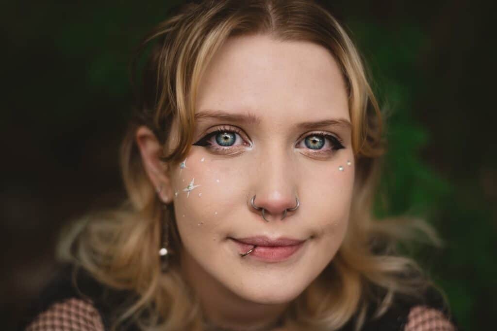 Close-up photograph of a person's face with glowing, futuristic digital data points and lines overlaid, symbolizing AI und...