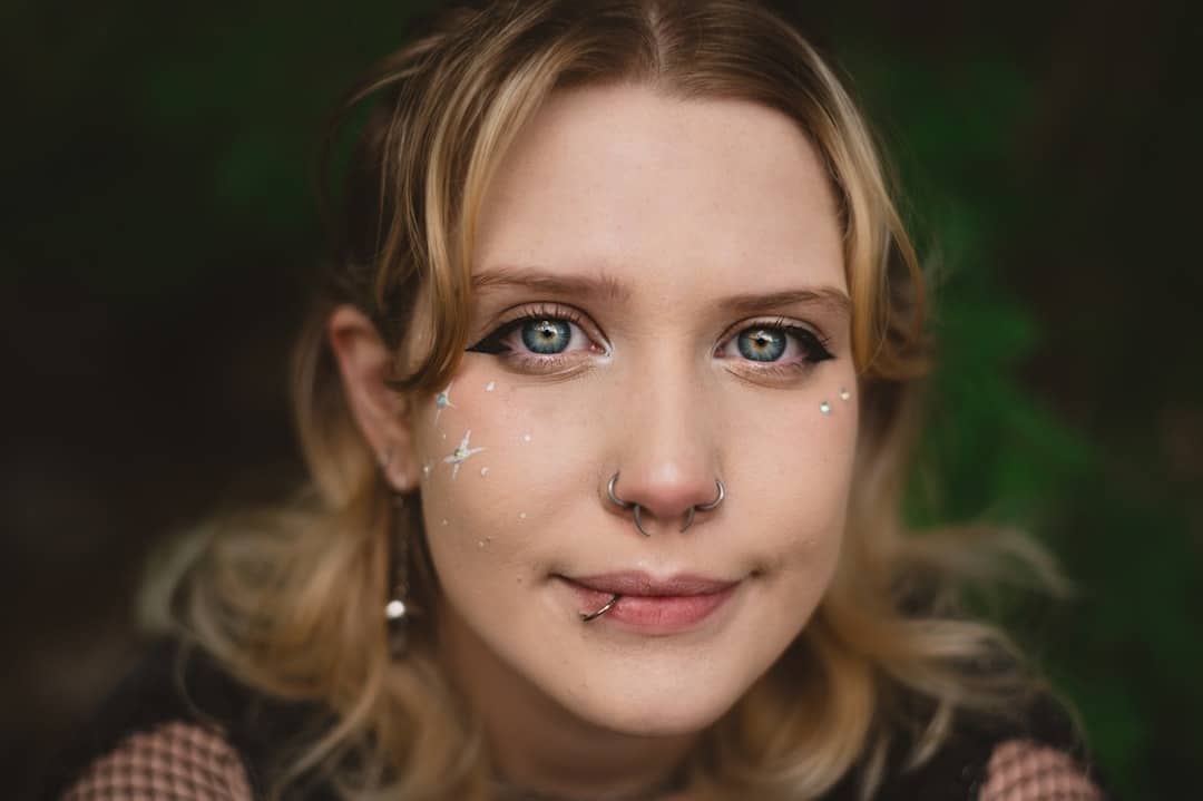 Close-up photograph of a person's face with glowing, futuristic digital data points and lines overlaid, symbolizing AI und...