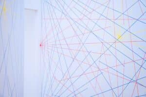 Person stands in front of a large, glowing abstract digital network, symbolizing the complexity of navigating future marke...