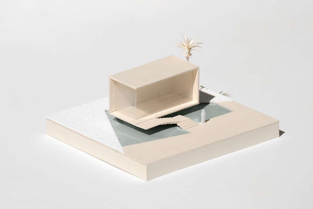 Clean, minimalist architectural model of a building on a white background, representing the foundational structure provide...