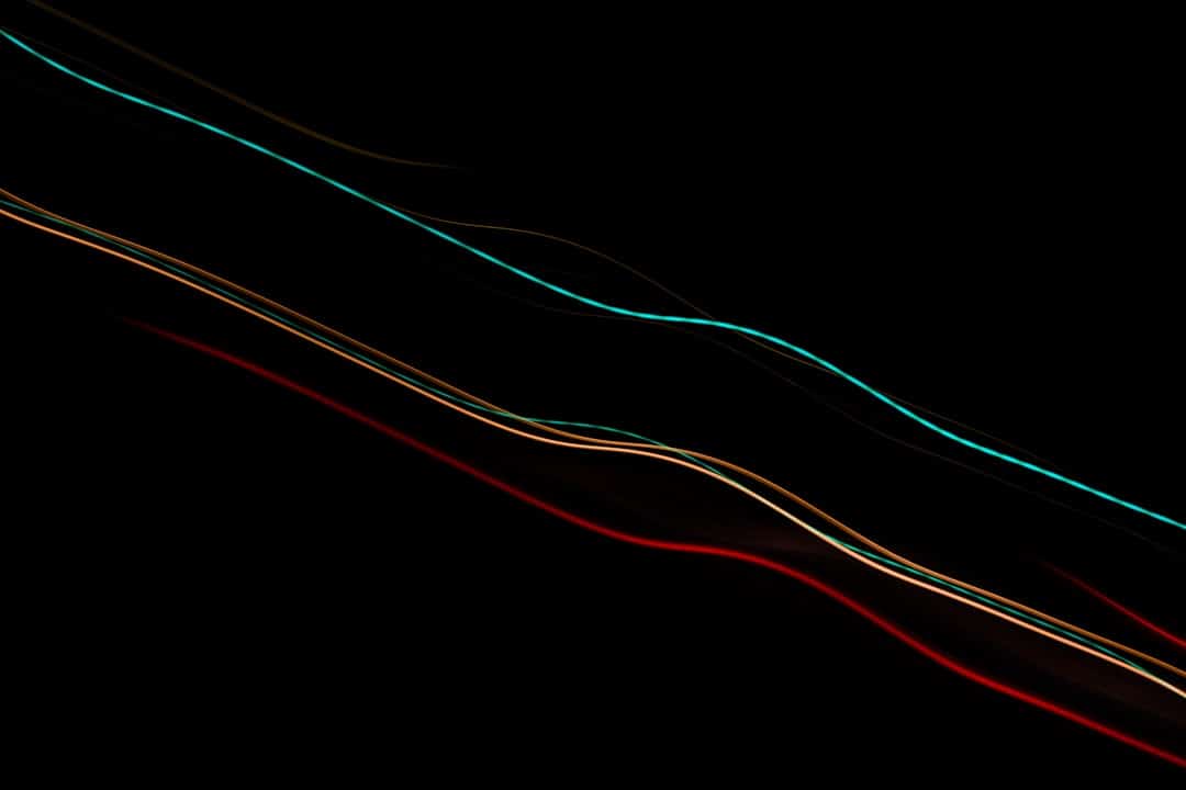 An abstract technological image with glowing blue and white lines of data moving through a dark space, representing the rise of AI and digital disruption.