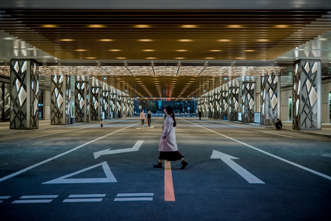 A person stands at the entrance to a large, modern maze, representing the complexity and challenge of adapting to new SEO rules.