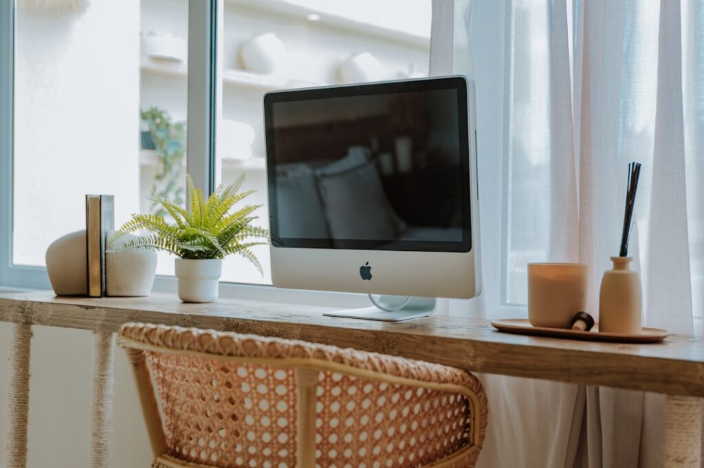 Professional real estate agent in a bright, modern office uses a digital tablet, symbolizing the integration of technology...