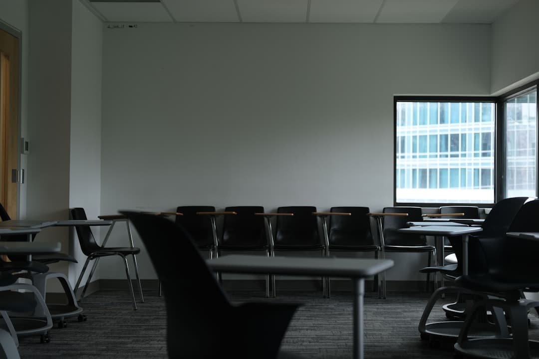 A single, modern chair sits alone in a vast, empty, minimalist room with concrete floors, illustrating the concept of being a digital tenant on rented land.