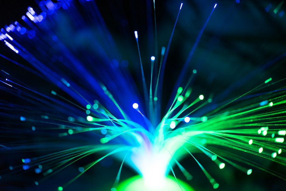 Abstract image of glowing blue and purple lines connecting nodes on a dark background, representing the shift from isolate...