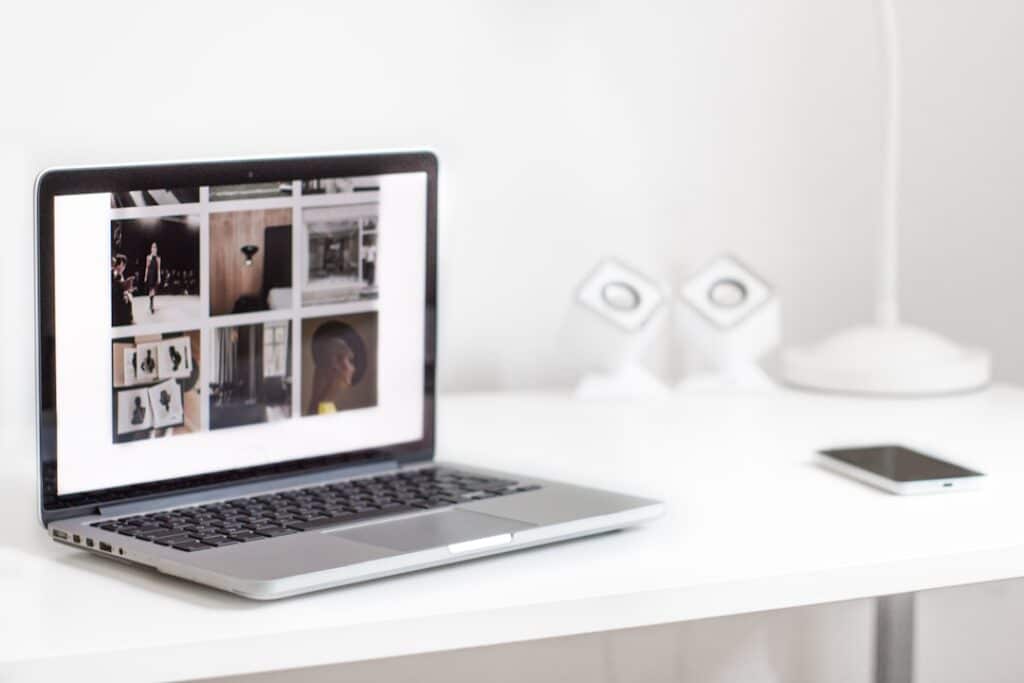 Focused small business owner works on a laptop in a bright, modern office, representing the accessibility of AI-powered ma...
