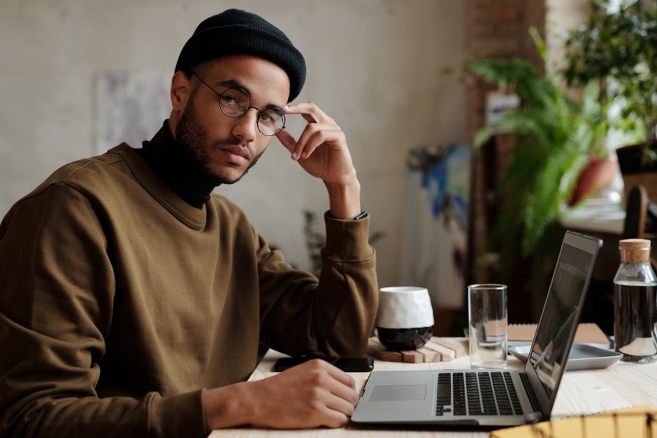A frustrated business owner looking at a laptop screen with a confused expression, illustrating the common experience of trying to understand opaque SEO packages.