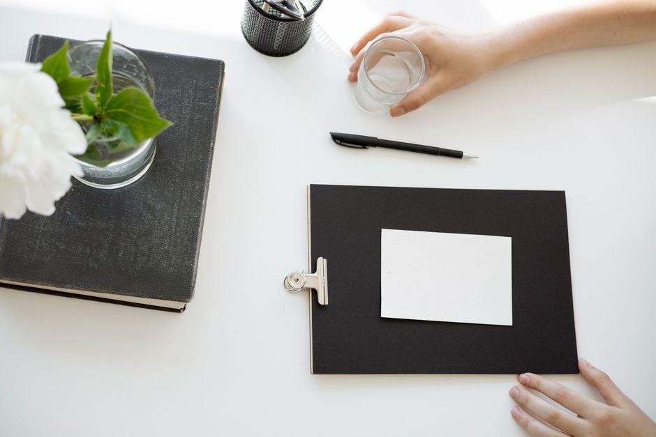 A person in a professional setting waters a small, thriving plant on a clean, modern office desk, illustrating the concept of long-term, sustained growth with an SEO retainer.