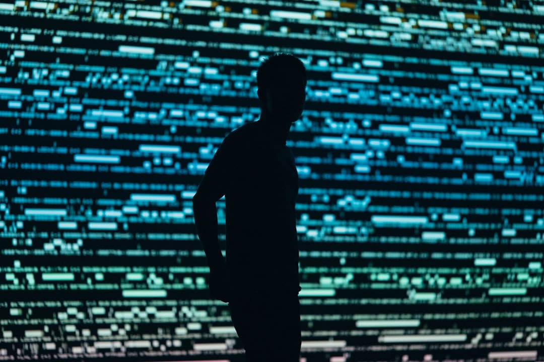 A person's hand touches a glowing, abstract data interface in a dark room, symbolizing the futuristic and insightful nature of AI analytics in marketing.