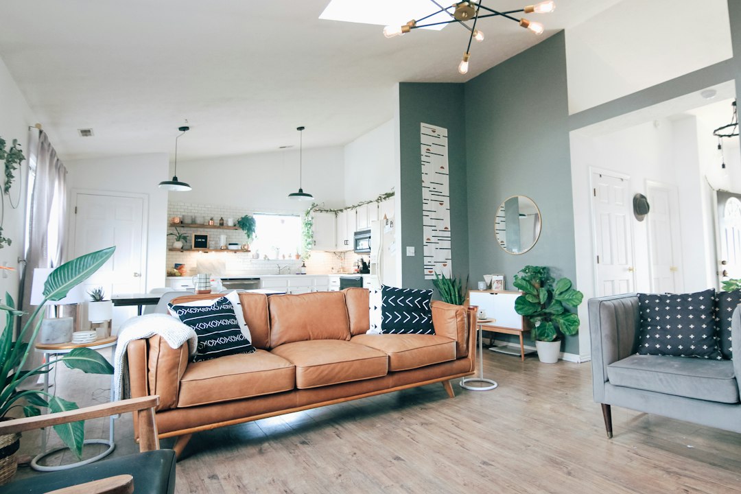 An airy and comfortable modern living room with plenty of natural light, representing the ideal comfortable home environment after proper insulation.