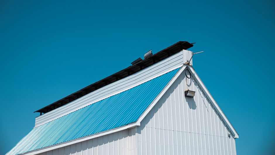 Close-up view of a newly constructed, modern residential roof with clean lines, showcasing high-quality materials and expe...