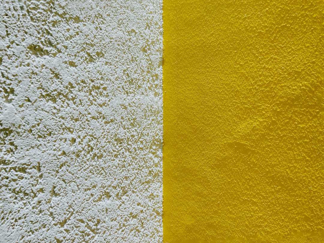 A detailed macro shot showing the clean, uniform texture of newly applied expanding spray foam insulation on a wall.